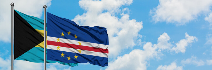 Bahamas and Cape Verde flag waving in the wind against white cloudy blue sky together. Diplomacy concept, international relations.