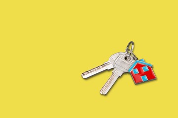 House and key on yellow background