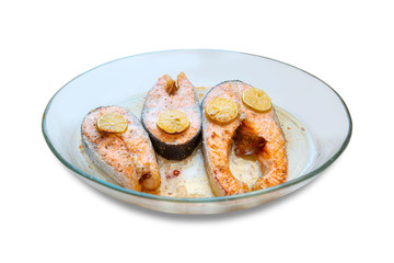 Baked in salmon in a glass baking dish isolated white background