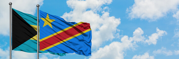 Bahamas and Congo flag waving in the wind against white cloudy blue sky together. Diplomacy concept, international relations.