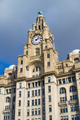 Fototapeta na wymiar Tower of the Royal Liver Building with a white clock in Liverpool, England, United Kingdom