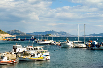 Fototapeta na wymiar Fishing boats at small harbour in Pachi village. Megara,Greece