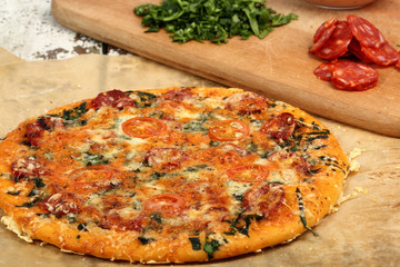Pizza with Salami and Tomatoes on the table