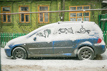 Dirty car in the snow on a village street