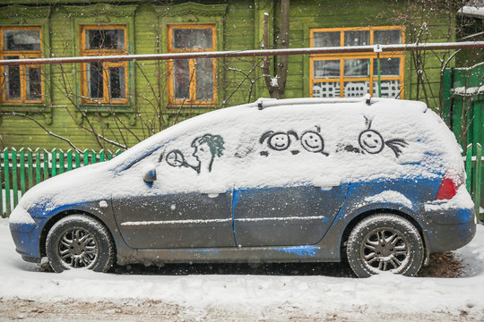 Dirty car in the snow on a village street