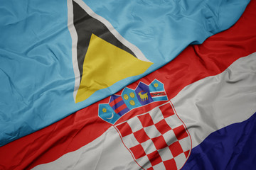 waving colorful flag of croatia and national flag of saint lucia.