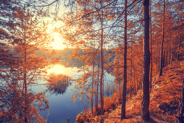 Autumn landscape. Rocky lakeshore at sunrise. Beautiful nature of Norway