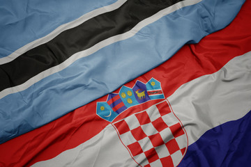 waving colorful flag of croatia and national flag of botswana.