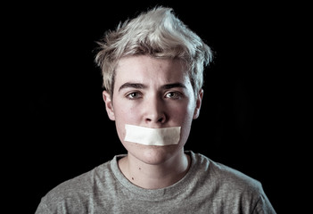 Conceptual image of censorship and social tabu. Transgender teenager with mouth sealed
