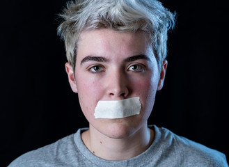 Conceptual image of censorship and social tabu. Transgender teenager with mouth sealed