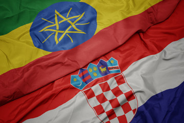 waving colorful flag of croatia and national flag of ethiopia .