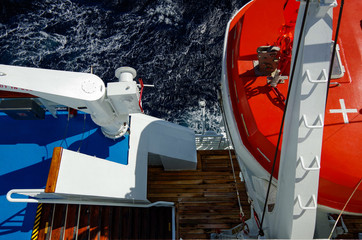 Birdseye View of wooden Teak deck on cruise ship promenade with stairs and lifeboat on cruise ship