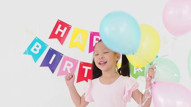 Happy little asian girl  with balloons in birthday party