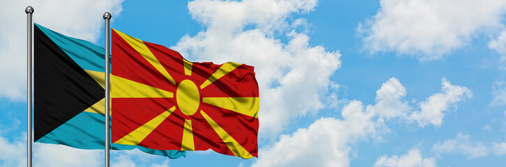 Bahamas and Macedonia flag waving in the wind against white cloudy blue sky together. Diplomacy concept, international relations.