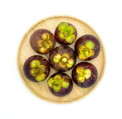 Garcinia mangostana on wooden dish,isolated on white background