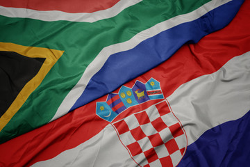 waving colorful flag of croatia and national flag of south africa.