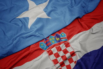 waving colorful flag of croatia and national flag of somalia.