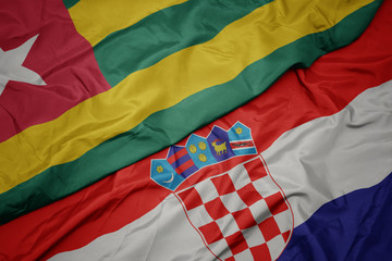 waving colorful flag of croatia and national flag of togo.
