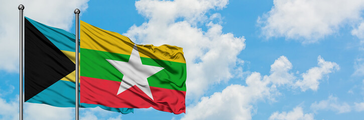 Bahamas and Myanmar flag waving in the wind against white cloudy blue sky together. Diplomacy concept, international relations.