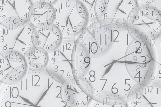 Background from set of white analog round office clocks of different sizes showing various time