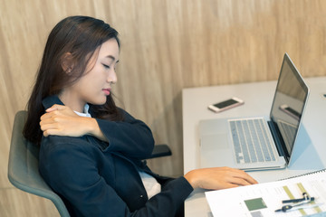 Picture of asian business woman has shoulder pain from working using computer