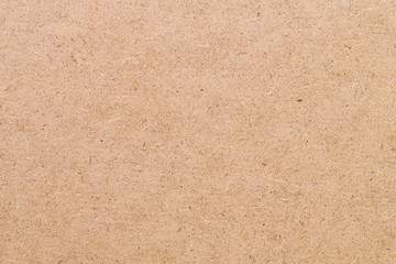 Flat lay closeup top view on a wooden surface of a fiberboard sheet. Modern abstract trendy texture background