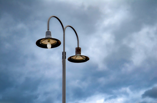 Street lamps against a dramatic blue sky