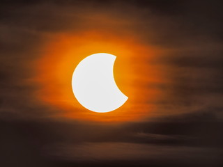view of sun solar eclipse in cloudy sky background, Solar eclipse of March 9, 2016 in Thailand.