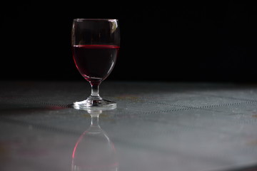 Red wine in wine glass on the table/Low-key concept