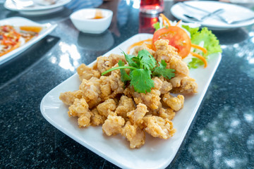 Deep fried chicken tendons on white in black stone dining table./ Blurred and selective focus.