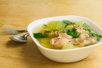 Chicken Clear soup in White Bowl on Wooden Table