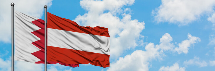 Fototapeta na wymiar Bahrain and Austria flag waving in the wind against white cloudy blue sky together. Diplomacy concept, international relations.