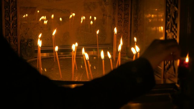 White burning wax candles on the altar of Orthodox Meteora monastery. Greece. 4K