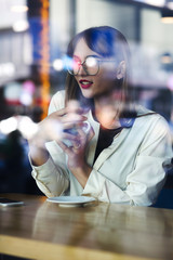 Pretty lady with red lips looking through the glass