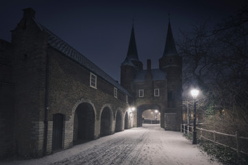 Fototapeta na wymiar Night, dark blue after a snowfall in the typical Dutch city. Delft, Holland