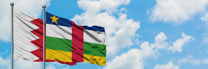 Bahrain and Central African Republic flag waving in the wind against white cloudy blue sky together. Diplomacy concept, international relations.