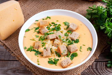 Delicious cheese cream soup with crackers