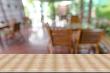 Top desk with blur restaurant background,wooden table