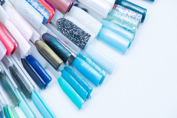 A palette of nail designs of different colors with gel polish on a white background. A collection of testers for nail polish.