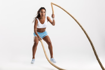 Confident young african sportswoman doing exercises