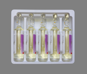 glass ampoules with injection drug in plastic packaging isolated on white background top view close...