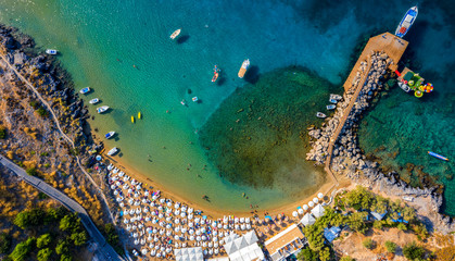 Aerial birds eye view photo taken by drone of iconic beaches in village of Lindos, Rhodes island, Dodecanese, Greece. - obrazy, fototapety, plakaty