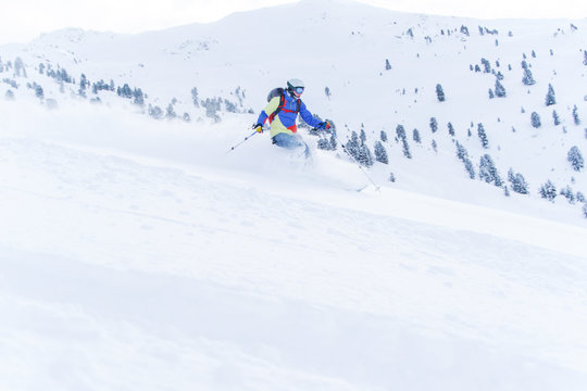 Image of sports man in mask and helmet skiing in winter resort