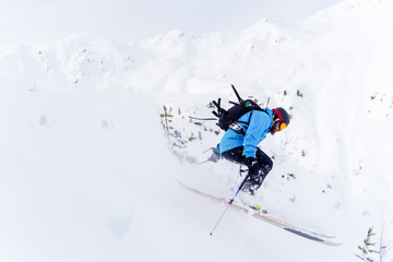 Side photo of athlete man with beard skiing
