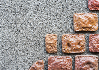The stone wall with a concrete coat in the form of splashes, drops, rough. lower right corner with decorative stone.