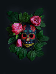 Sugar skull mask with flowers used for celebrating Day of the Dead in hispanic culture. Mexican symbol of the traditional Dia de los Muertos.