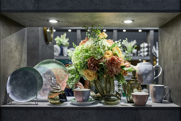 a showcase with the laying of porcelain dishes. Beautiful merchandising, dishes for restaurants and hotels
