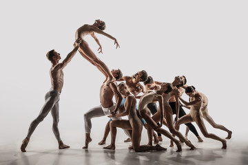 The group of modern ballet dancers. Contemporary art ballet. Young flexible athletic men and women...
