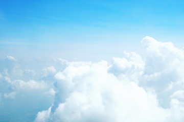 blue sky background with clouds, beautiful cloudscape, view over white fluffy clouds, freedom concept