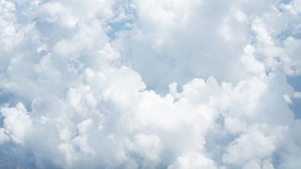 blue sky background with clouds, beautiful cloudscape, view over white fluffy clouds, freedom concept
